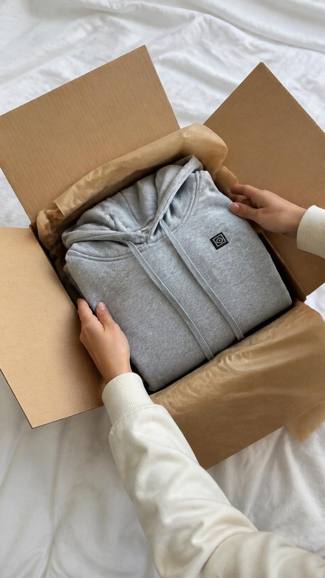 Grauer ArticLux Hoodie beim Auspacken